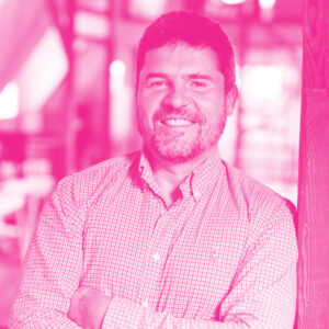 Andrus Oks' headshot with a hot pink filter.