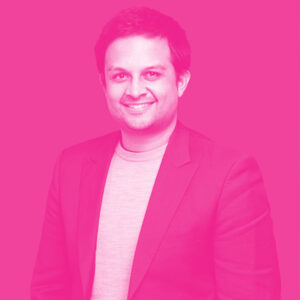 Eeshan Kulkarni's headshot with a hot pink filter.