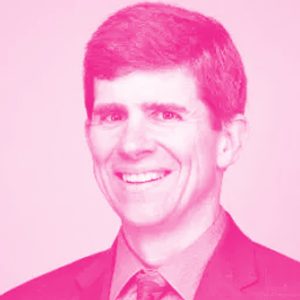 George Savage&#039;s headshot with a hot pink filter.