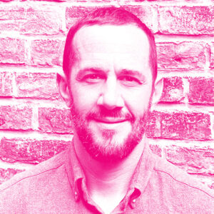 Isaac Souweine&#039;s headshot with a hot pink filter.