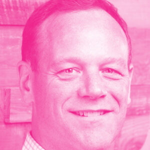 Jaimie Pickles' headshot with a hot pink filter.