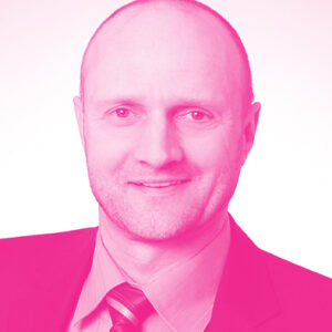 Jörg Stein's headshot with a hot pink filter.