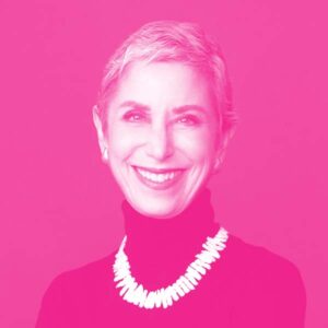 Karen Teitelbaum's headshot with a hot pink filter.