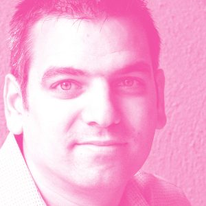 Michael Kuhlmann's headshot with a hot pink filter.