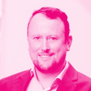 Stuart Cain's headshot with a hot pink filter.