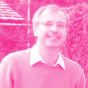 Yves Balkanski's headshot with a hot pink filter.